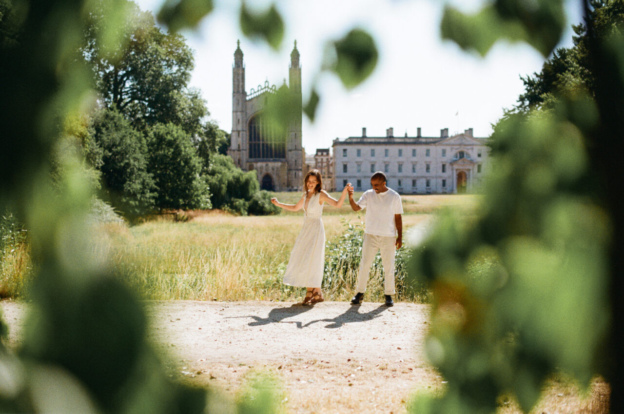 A couple dance at The Backs in Cambridge with King's College in the background.