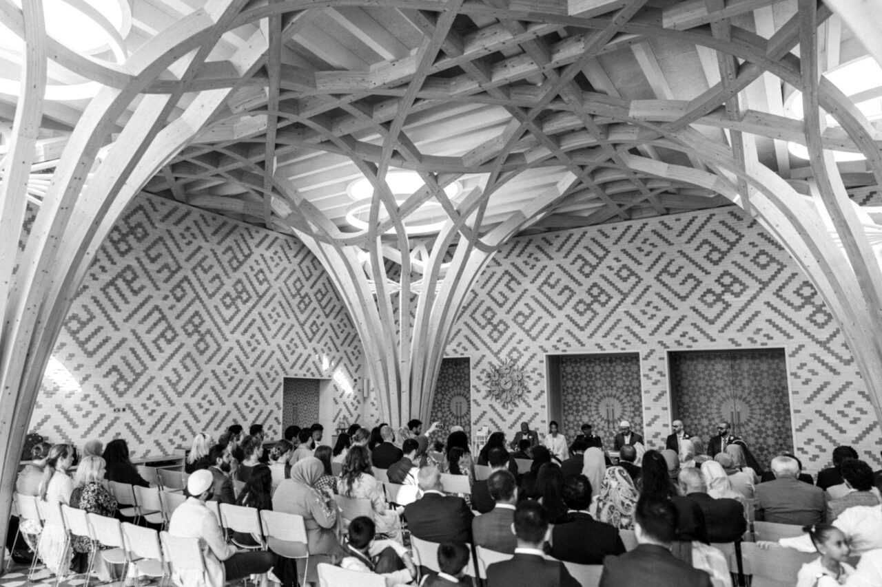Wide angle photograph of a Muslim nikkah marriage ceremony in the main foyer of Cambridge Central Mosque.
