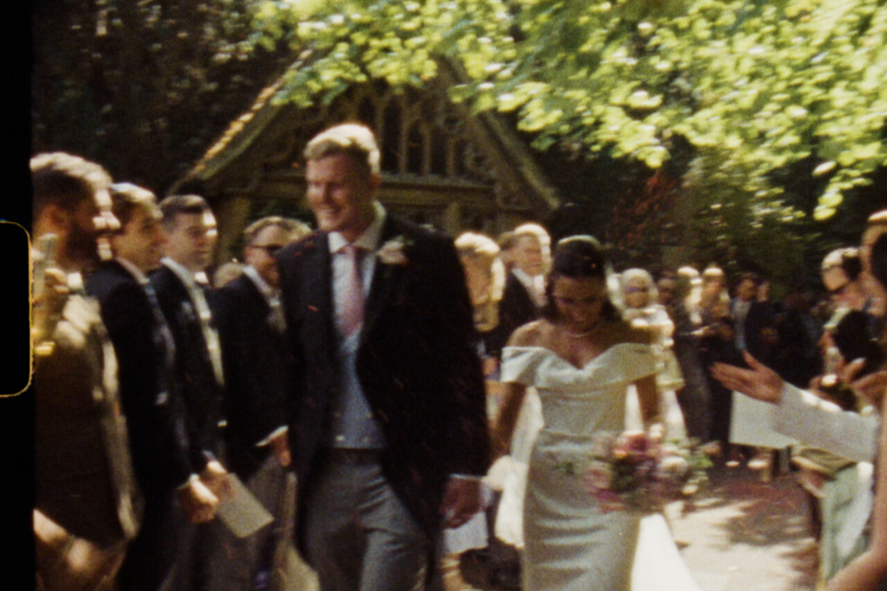 Super 8 wedding videography - a bride and groom with confetti on colour.