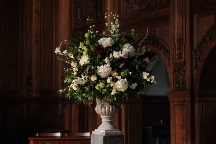 Elegant floral arrangement photographed by a Lincolnshire wedding photographer, capturing wedding details in a historic interior setting.