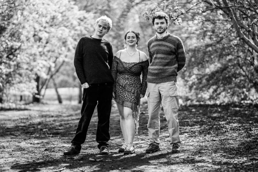 Portrait of brothers and sister in London park.