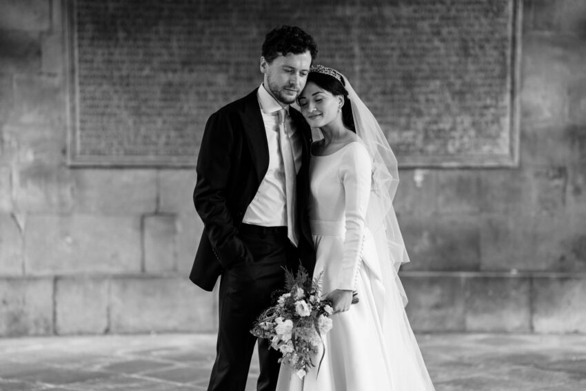 Bride and groom standing together just after the ceremony at Emmanuel College, Cambridge
