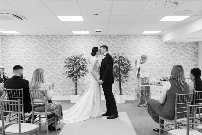 Bride and groom standing together during a civil ceremony at the Cambridge registry office