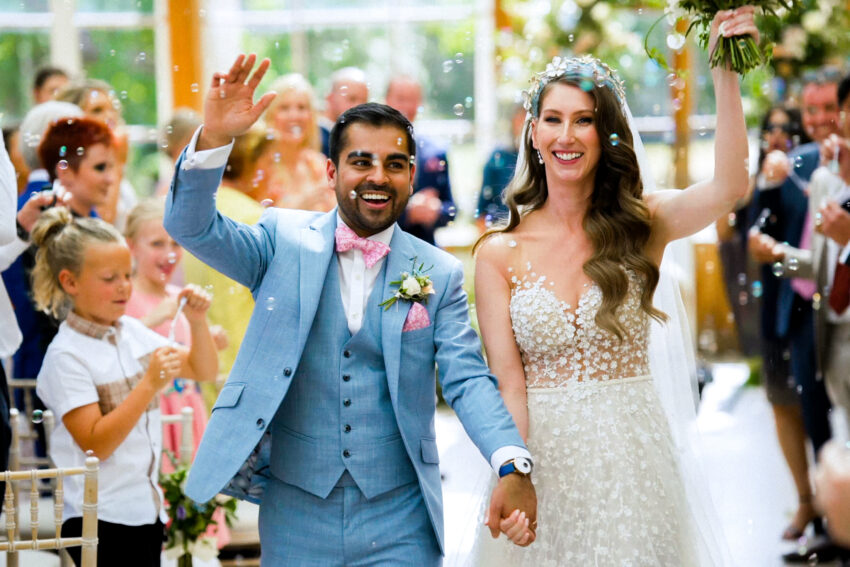 A couple celebrate after their wedding ceremony at Kew Gardens.