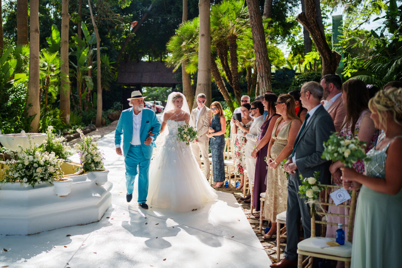 Bridal entrance with guests watching, outdoor ceremony atmosphere in Málaga