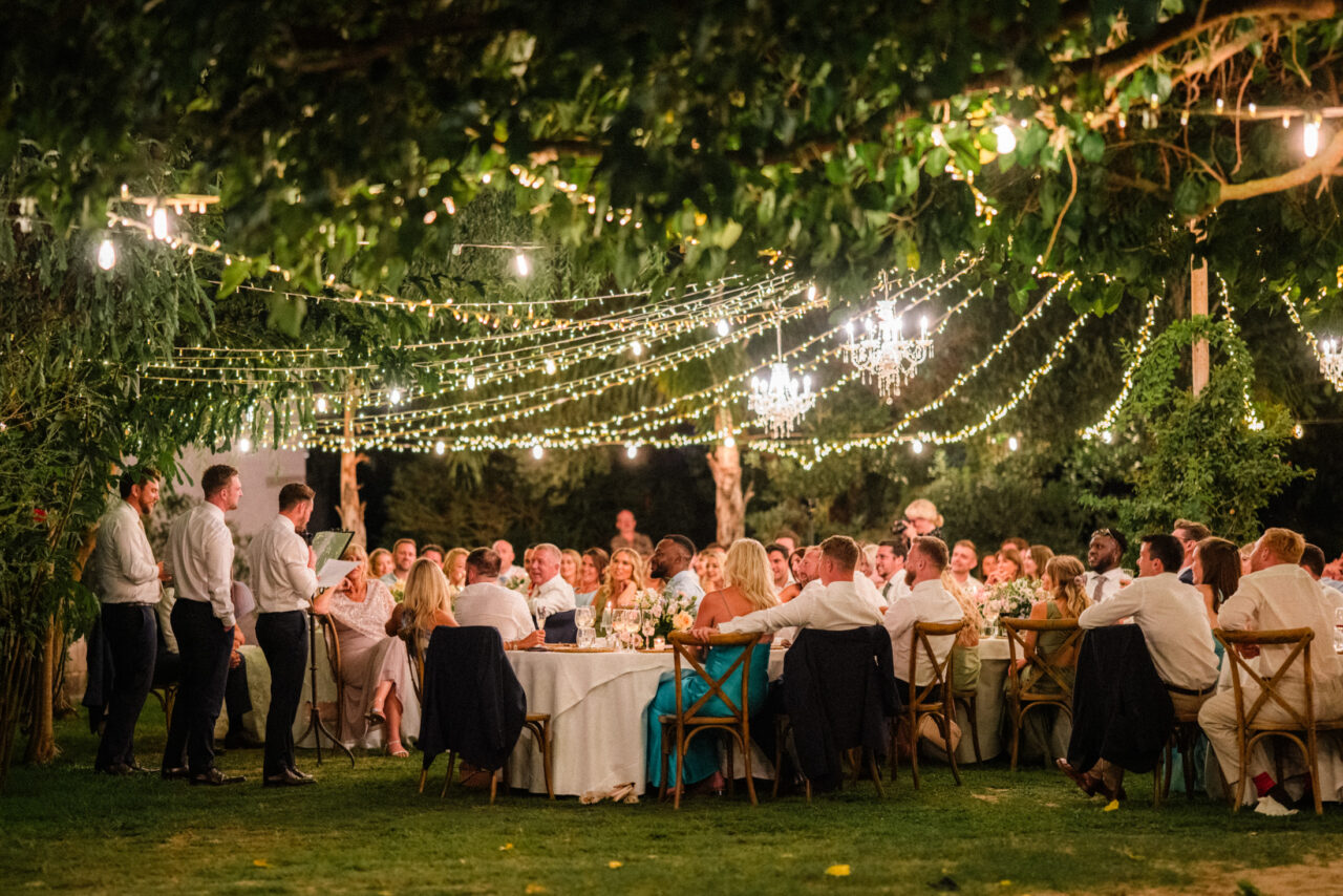 Outdoor wedding dinner under string lights, romantic Spanish wedding reception atmosphere