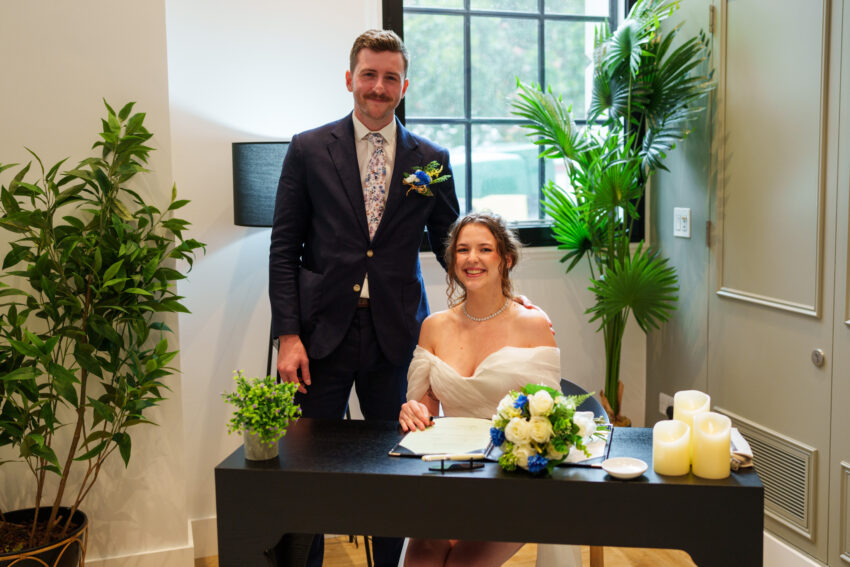 Bride and groom posing together after signing the register at Camden Town Hall.