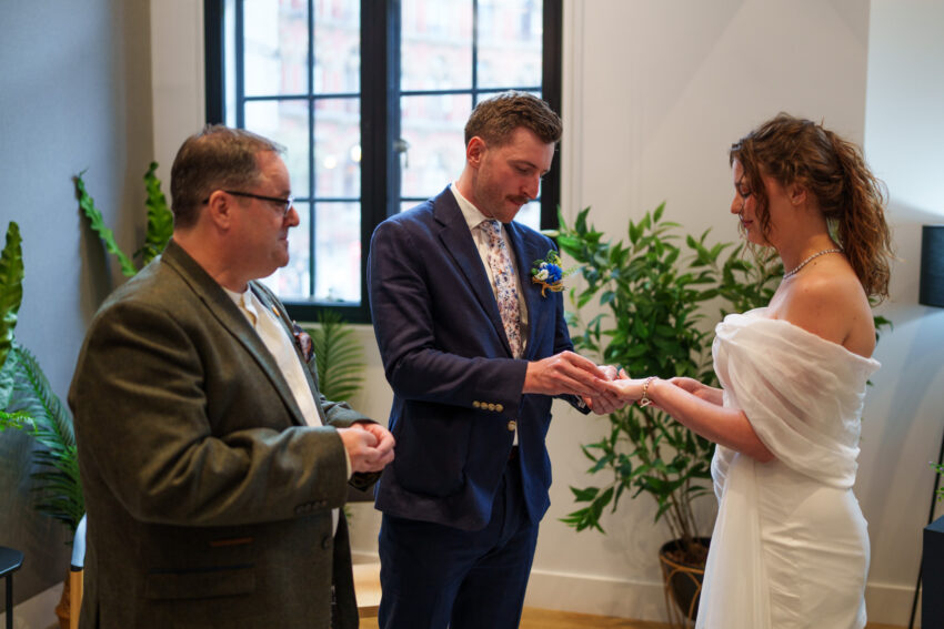 Exchange of rings during a wedding ceremony at Camden Town Hall.