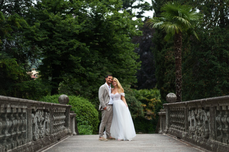 Couple walking together through gardens during a Lake Como couples photoshoot.