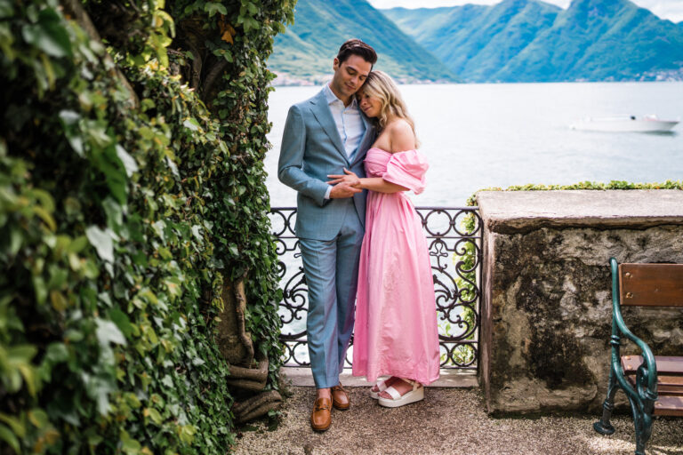 Couple standing close together and holding hands at Villa del Balbianello, Lake Como.