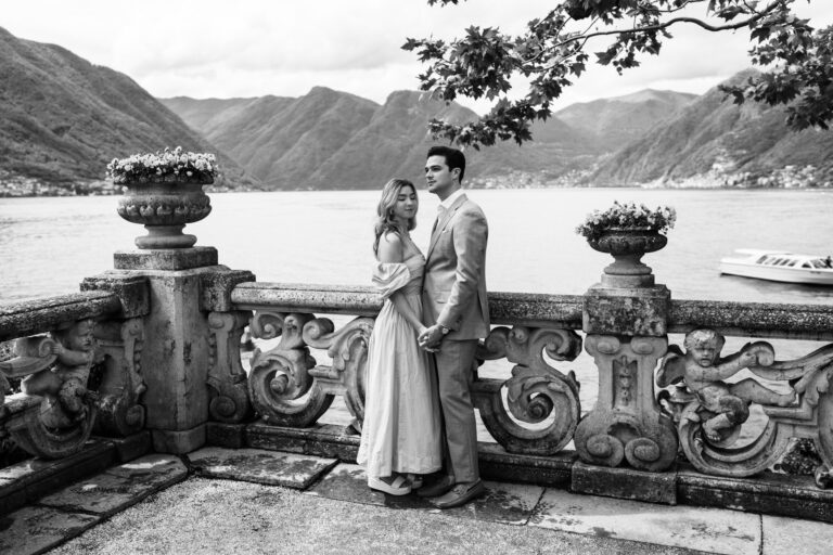 Black and white portrait of a couple standing together overlooking the lake at Villa del Balbianello, Lake Como.