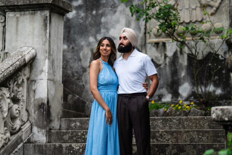 Couple standing close together on the steps at Villa Monastero during a Lake Como couples photoshoot.