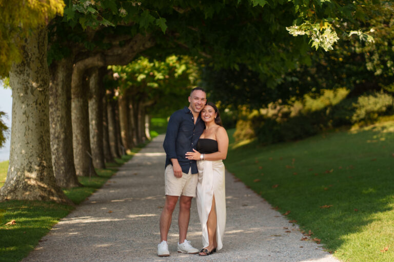 Couple walking arm in arm along a tree-lined path at Villa Melzi during a Lake Como couples photoshoot.