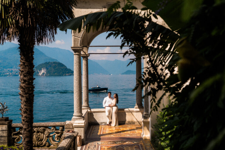 Couple standing together beneath the colonnade at Villa Monastero during a Lake Como couples photoshoot.
