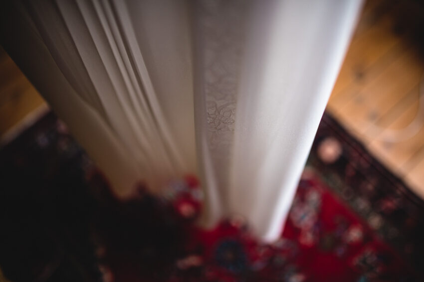 Close detail of a wedding dress fabric, soft folds and texture.