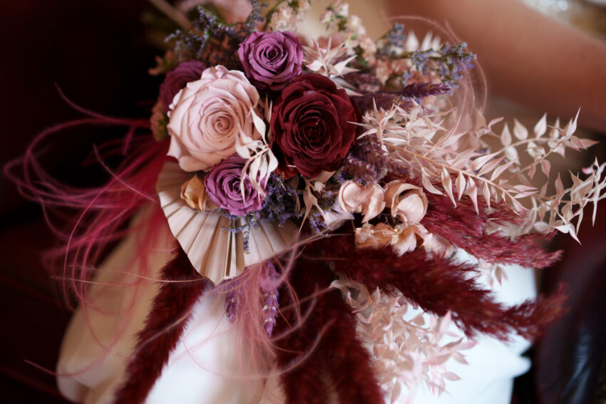 Close-up of the bride’s wedding bouquet with dried flowers and soft neutral tones.