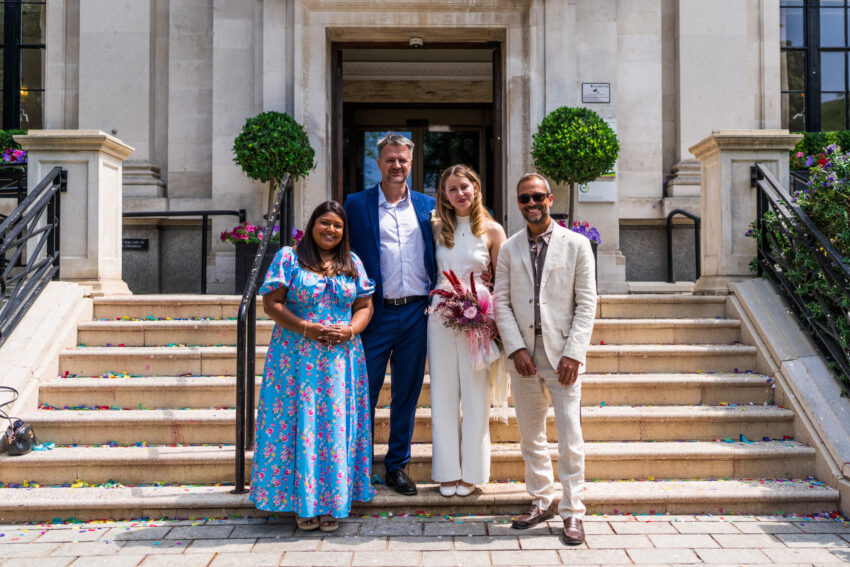 Bride, groom and guests outside Islington Town Hall.