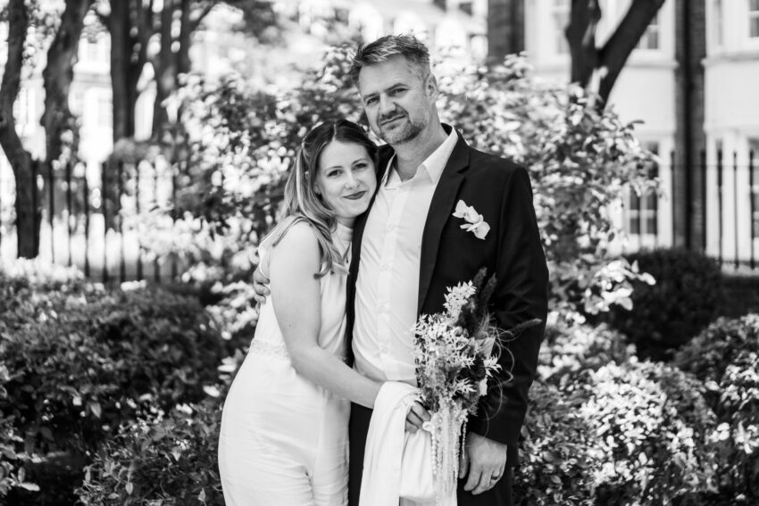 Black and white portrait of the bride and groom together outdoors after their wedding ceremony.