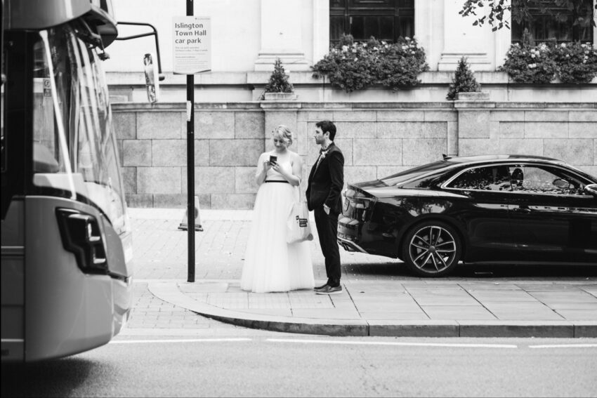 Bride and groom standing together outside Islington Town Hall after their wedding ceremony.