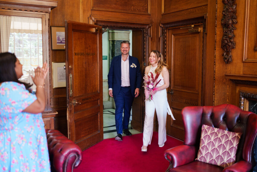 Bride and groom walking into the Mayor’s Parlour together following the ceremony.