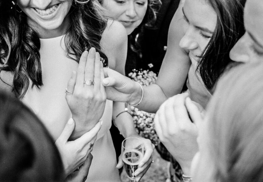 Guests gathered outdoors for drinks beneath a large tree.