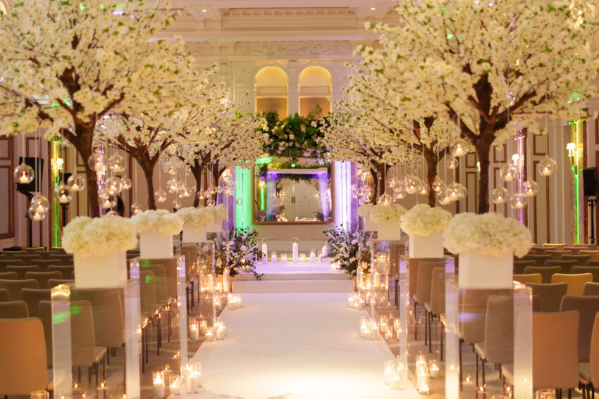Floral-lined wedding aisle inside the ballroom at Kimpton Fitzroy.