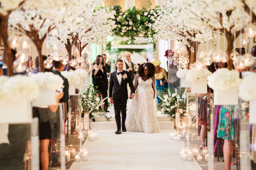 Wedding couple exiting the ceremony together at Kimpton Fitzroy London.