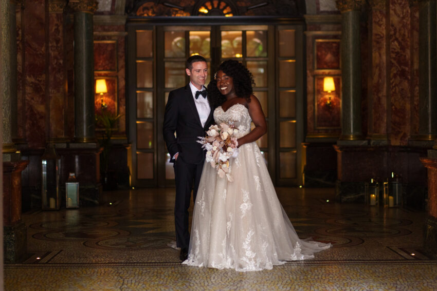 Wedding couple standing together outside the entrance to Kimpton Fitzroy.