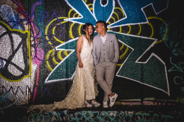Couple photoshoot in London beside colourful street art, modern editorial feel