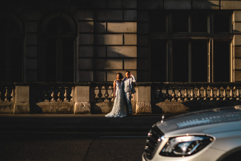 Bride and groom in dramatic evening light on Horseguards Avenue.