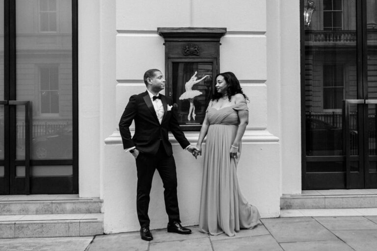 Black and white couple laughing outside the Royal Opera House in Covent Garden, London