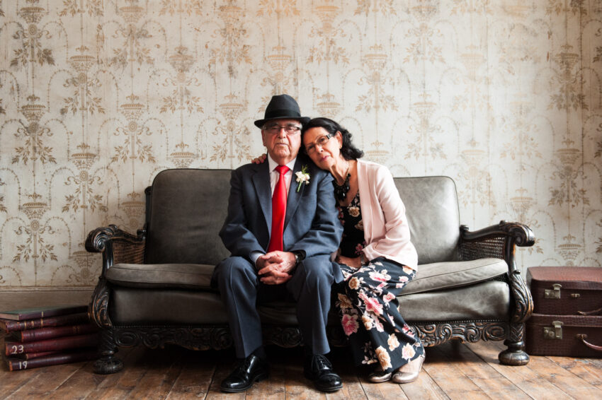 Couple seated on sofa at wedding venue in London.