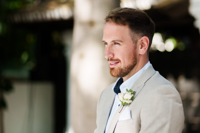 Groom smiling during wedding ceremony at Marbella Club Hotel.
