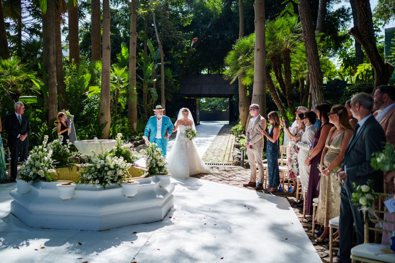 Outdoor wedding ceremony at a Marbella venue with tropical gardens near Malaga.