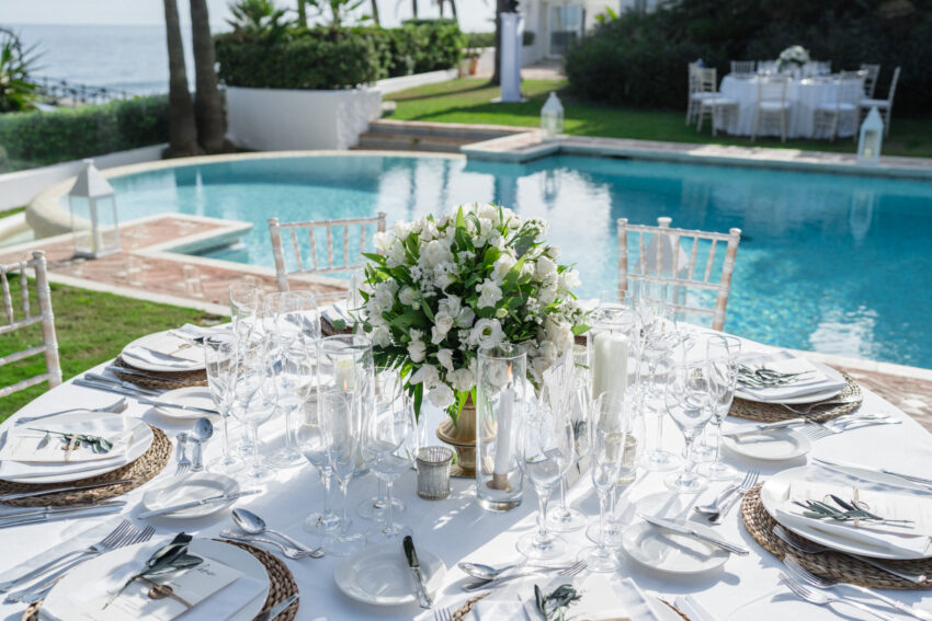Reception table styling beside the pool at Marbella Club Hotel with white floral centrepiece.