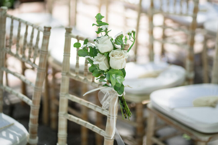 Floral detail tied to gold Chiavari chair at Marbella Club Hotel reception.