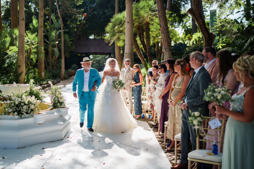 Bride and her father walk down the aisle at Marbella Club in Spain.