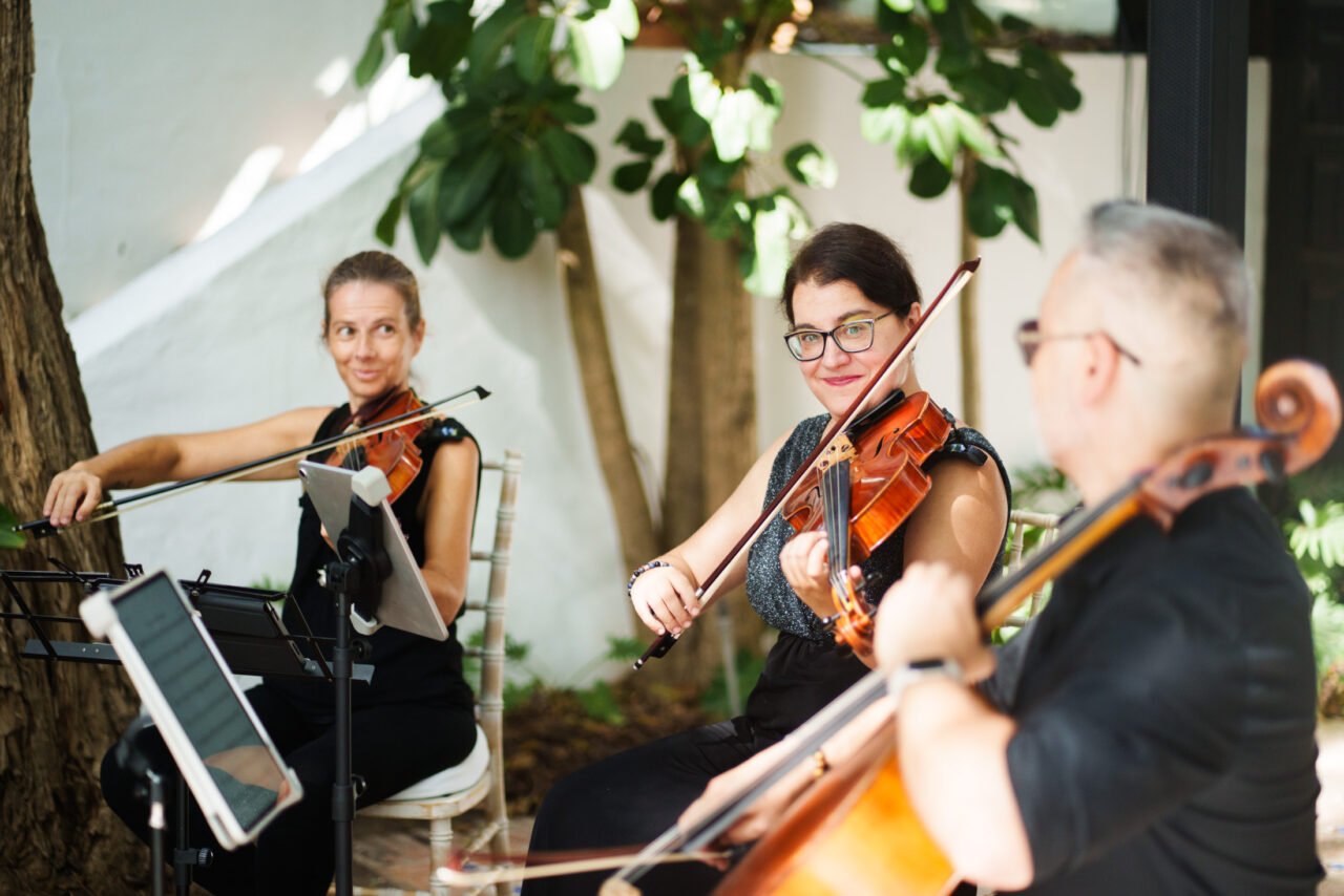 Live string musicians playing during a Marbella Club wedding in Marbella.
