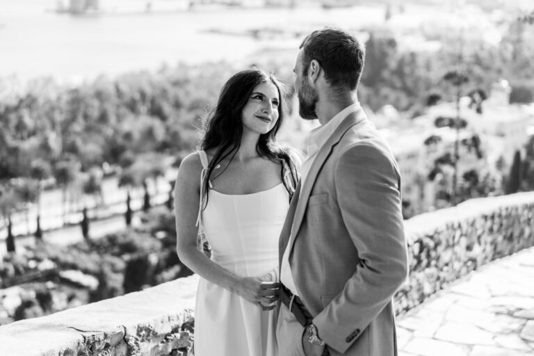 Couple standing together on the Gibralfaro viewpoint overlooking Málaga.