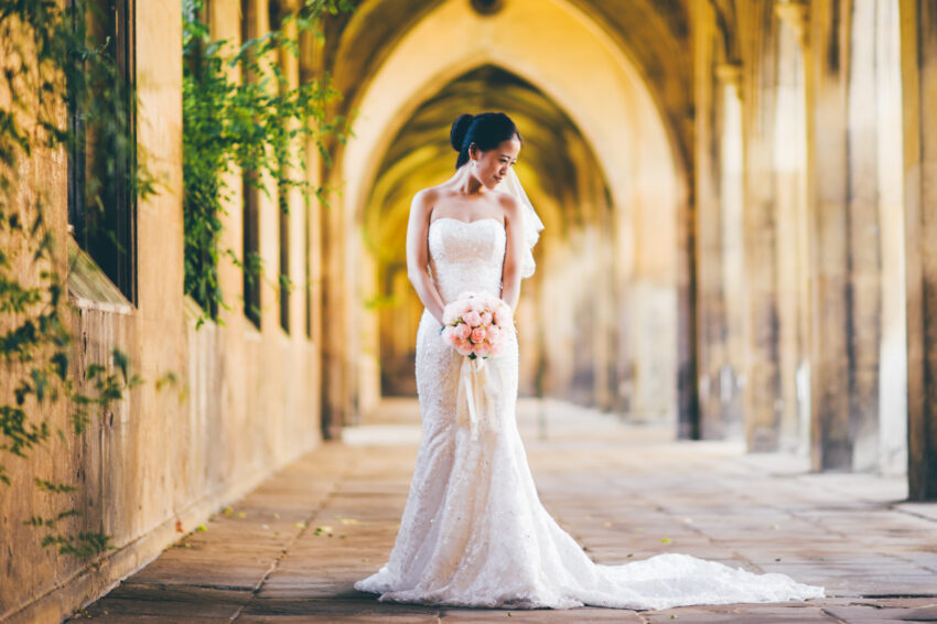 Elegant bridal portrait in the atmospheric cloisters at St John’s College Cambridge.