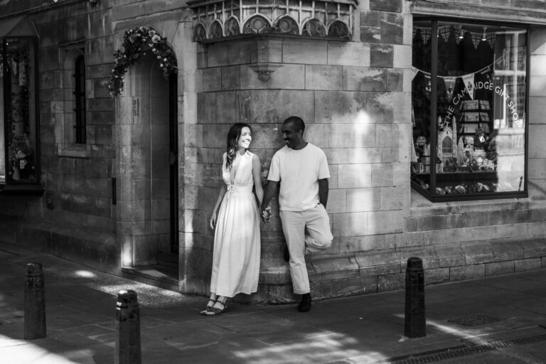 Couple standing outside a historic building in Cambridge city centre.
