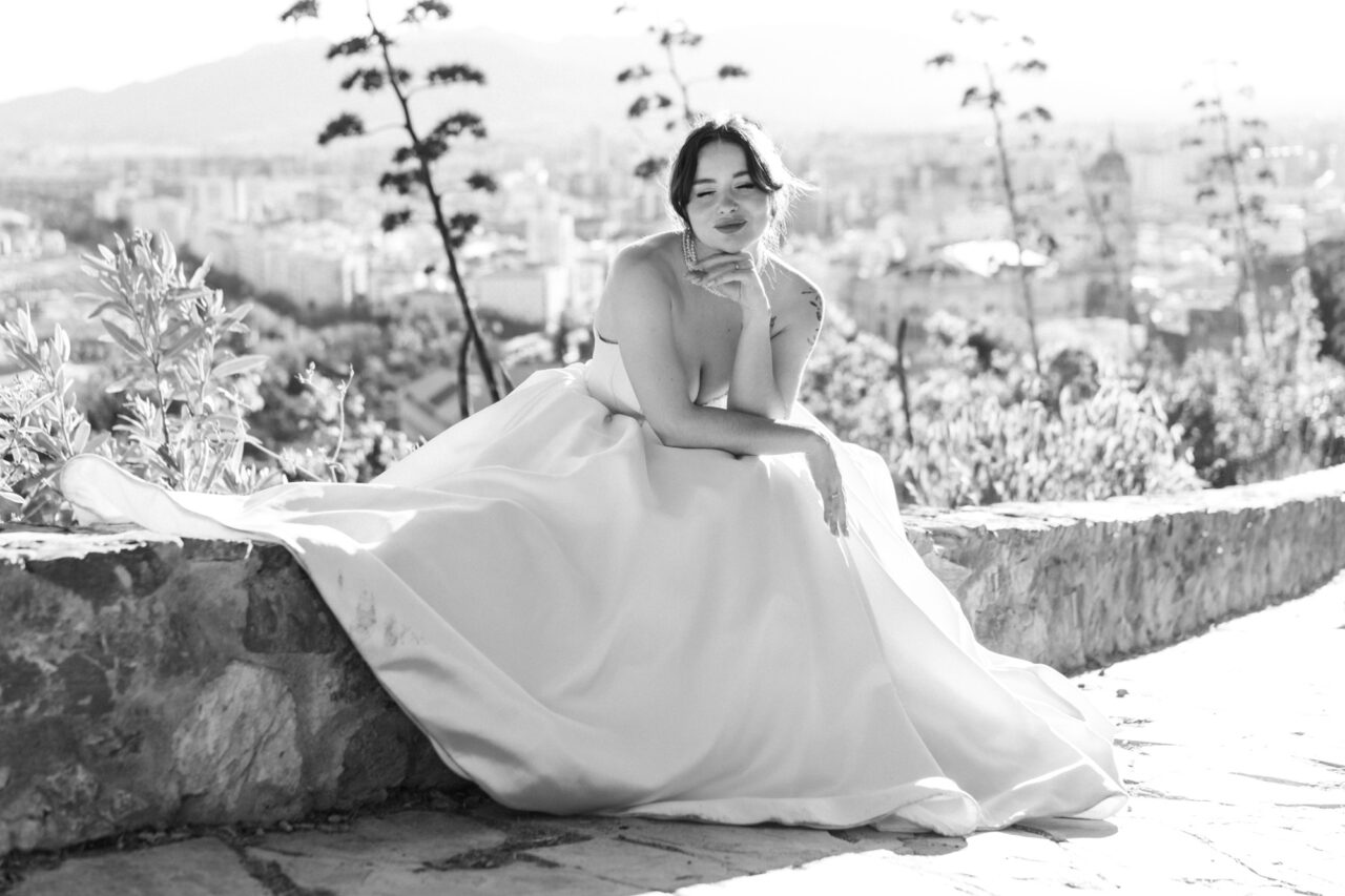 Bridal portrait at Gibralfaro hill overlooking Malaga, black and white composition.