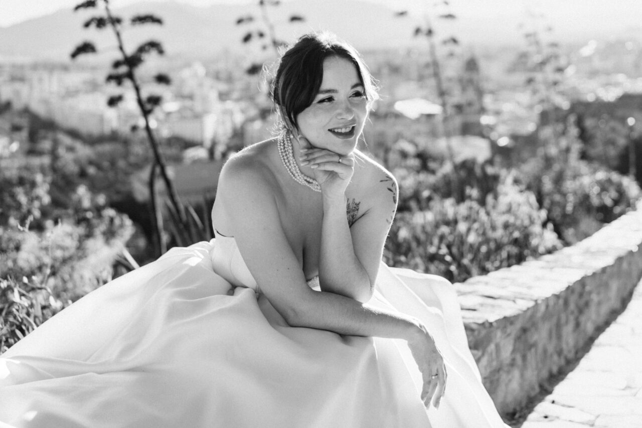 Bridal portrait at Gibralfaro hill overlooking Malaga, black and white image with city views.