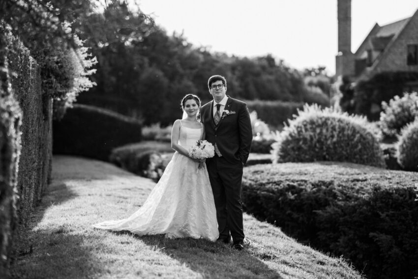 Bride and groom portrait in the formal gardens at The Old Hall Ely wedding venue Cambridgeshire.
