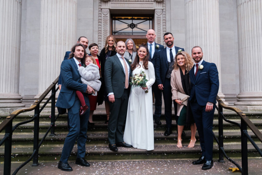 Wedding party gathered on the steps outside Old Marylebone Town Hall.