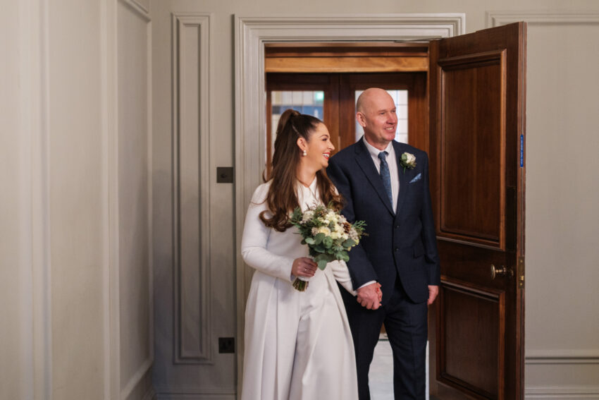 Bride entering the Pimlico Room with her father at Old Marylebone Town Hall.