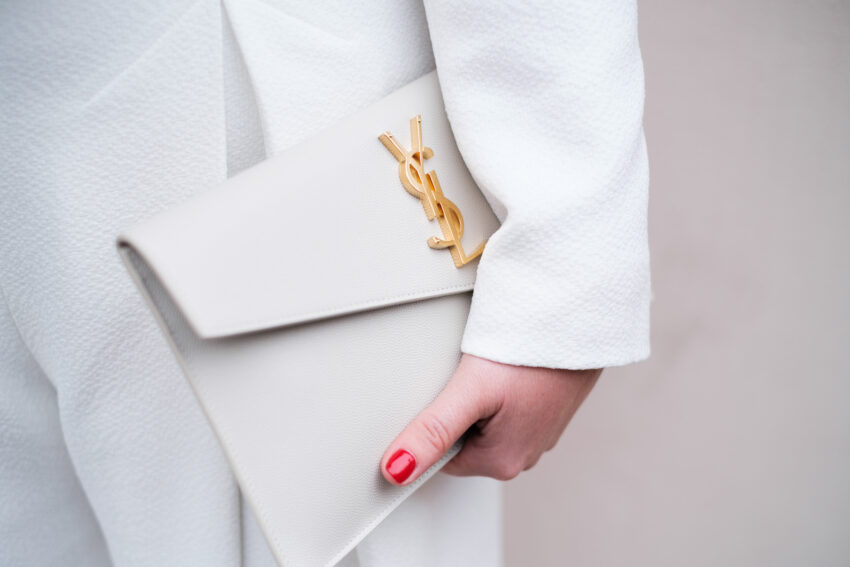 Close detail of a Saint Laurent clutch held by the bride on her wedding day.