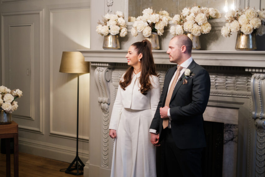 Bride and groom standing together during their ceremony in the Pimlico Room.