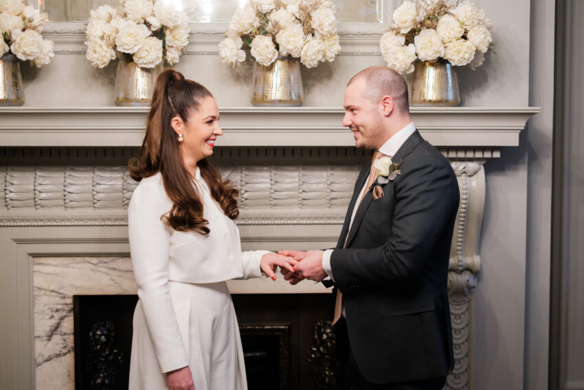 Bride and groom exchanging rings during their ceremony in the Pimlico Room at Old Marylebone Town Hall.