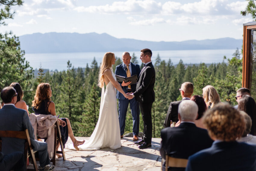 Guests watching the ceremony with Lake Tahoe and mountain views behind.